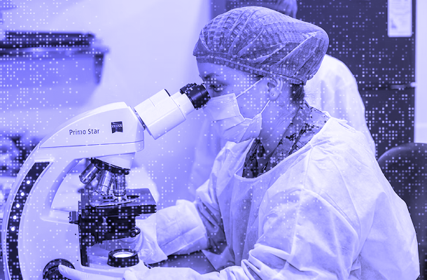 Lab technician working on microscope